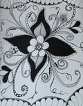 Intricate black and white doodle flower with swirling vines and zentangle patterns