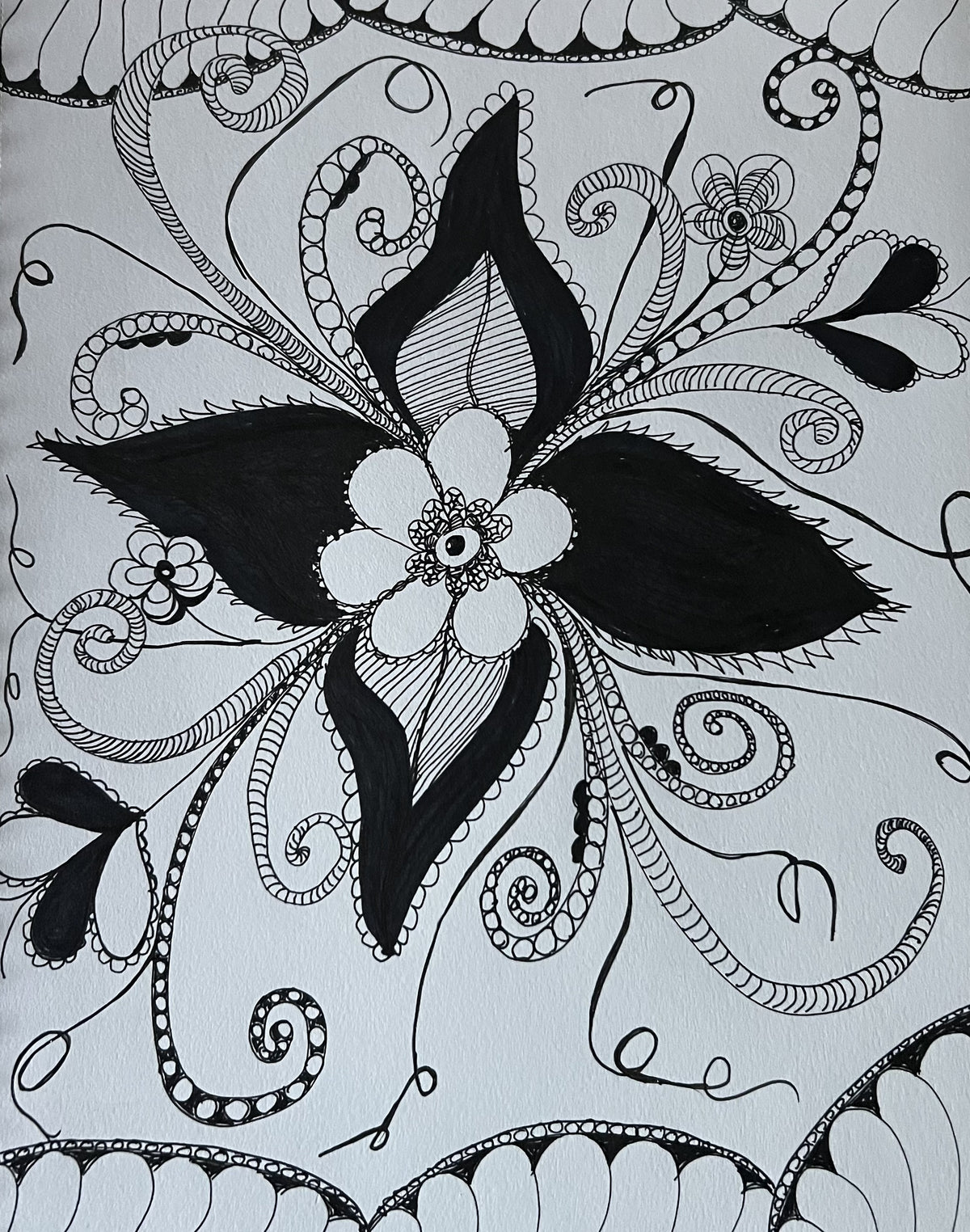 Intricate black and white doodle flower with swirling vines and zentangle patterns
